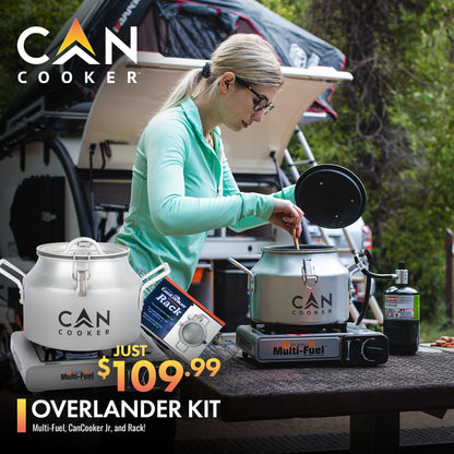Overlander Kit with CanCooker Jr., multi-fuel burner, and rack in use at a campsite. Ideal for outdoor cooking, feeds up to 8 people.